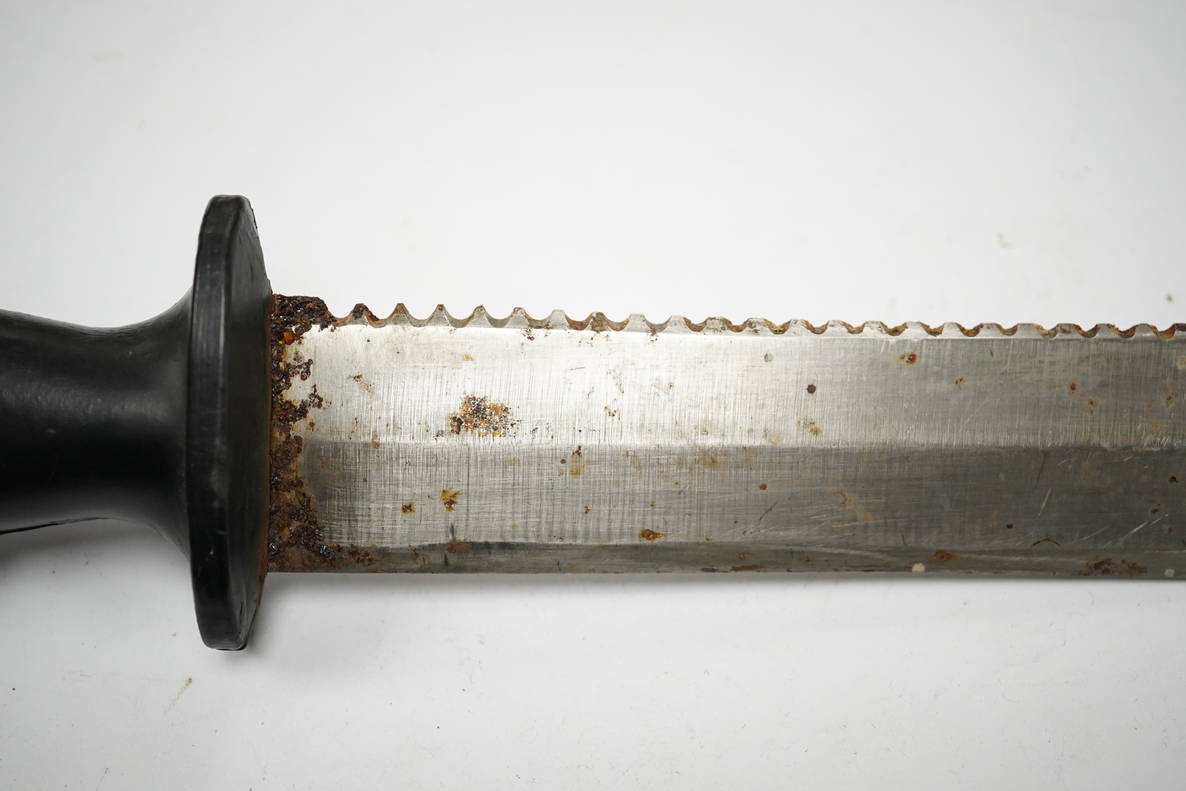 A Siebe Gorman & Co diving knife, regulation blade, turned wooden handle, brass cross piece with brass sheath, poor condition, together with another driver’s knife with sawback blade, etched John Noel and Sons, Sheffield